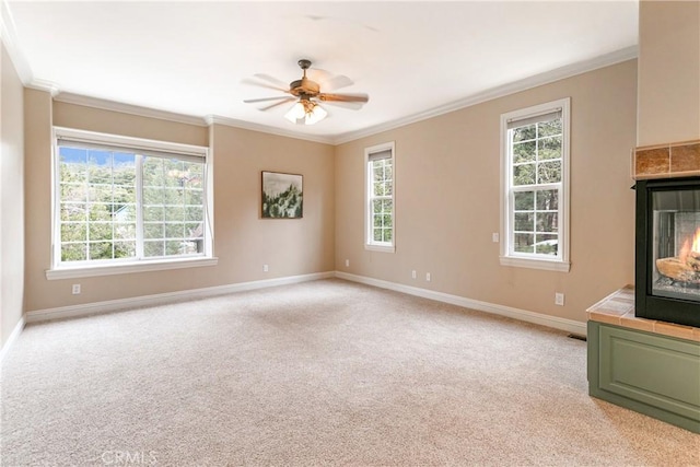unfurnished living room with plenty of natural light, baseboards, and ornamental molding