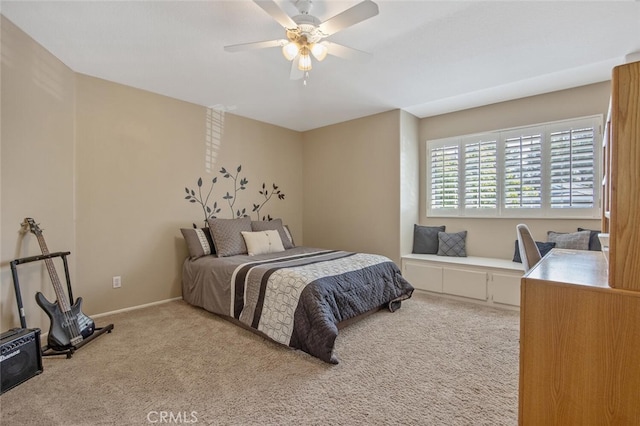 bedroom with ceiling fan, light carpet, and baseboards