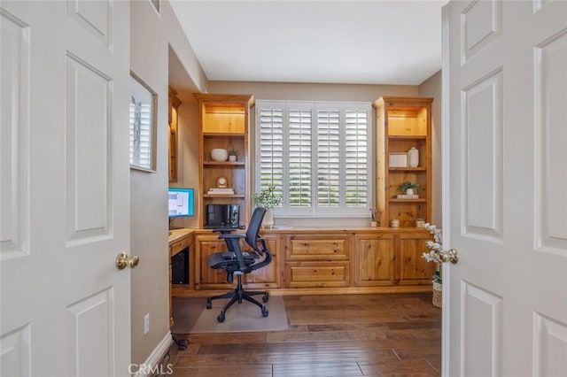 home office with built in desk and wood-type flooring