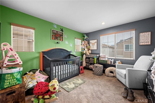 carpeted bedroom with a crib