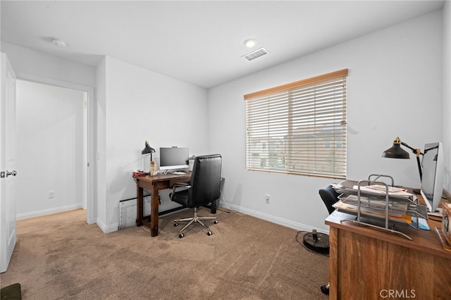 carpeted home office with baseboards and visible vents