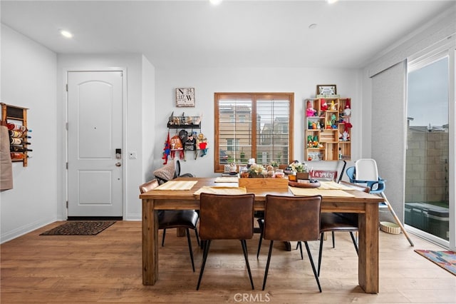 dining area featuring recessed lighting and light wood-style flooring