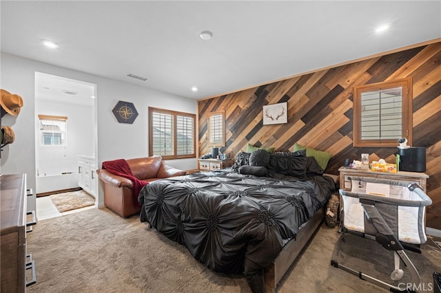 bedroom featuring carpet floors, recessed lighting, wooden walls, and visible vents