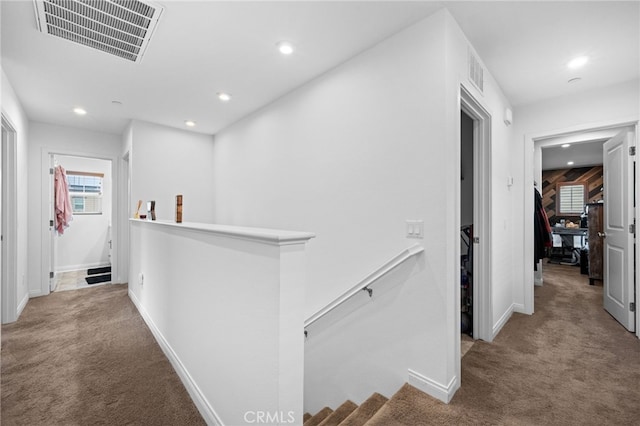 corridor with visible vents, carpet flooring, recessed lighting, and an upstairs landing