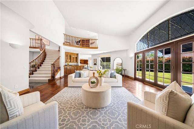 519 Connie Rae Way, Arcadia, CA 91006 - living room with a towering ceiling, wood finished floors, stairway, baseboards, and french doors
