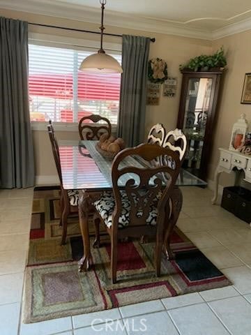 dining room with ornamental molding and tile patterned floors