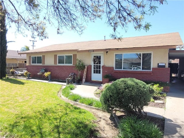 single story home with a front yard, brick siding, and stucco siding