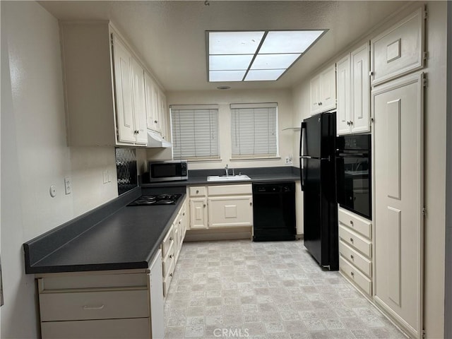 661 Avenida Sevilla Unit O, Laguna Woods, CA 92637 - kitchen featuring black appliances, dark countertops, and white cabinets