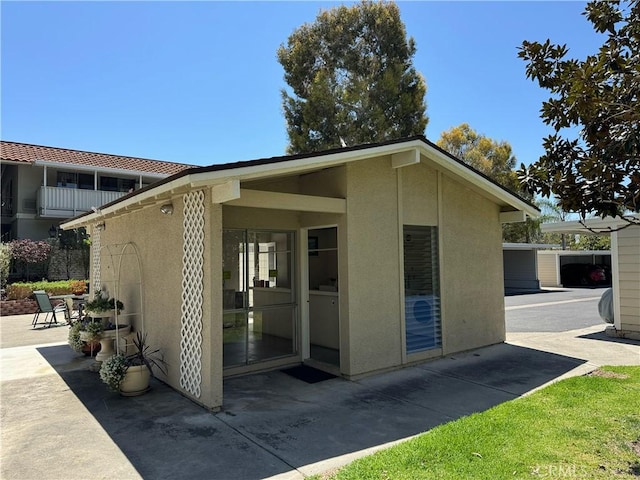 661 Avenida Sevilla Unit O, Laguna Woods, CA 92637 - rear view of house featuring stucco siding and a patio