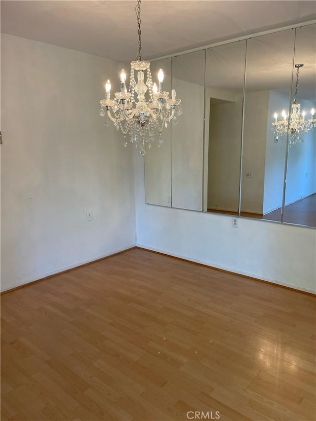 661 Avenida Sevilla Unit O, Laguna Woods, CA 92637 - spare room with a chandelier and wood finished floors