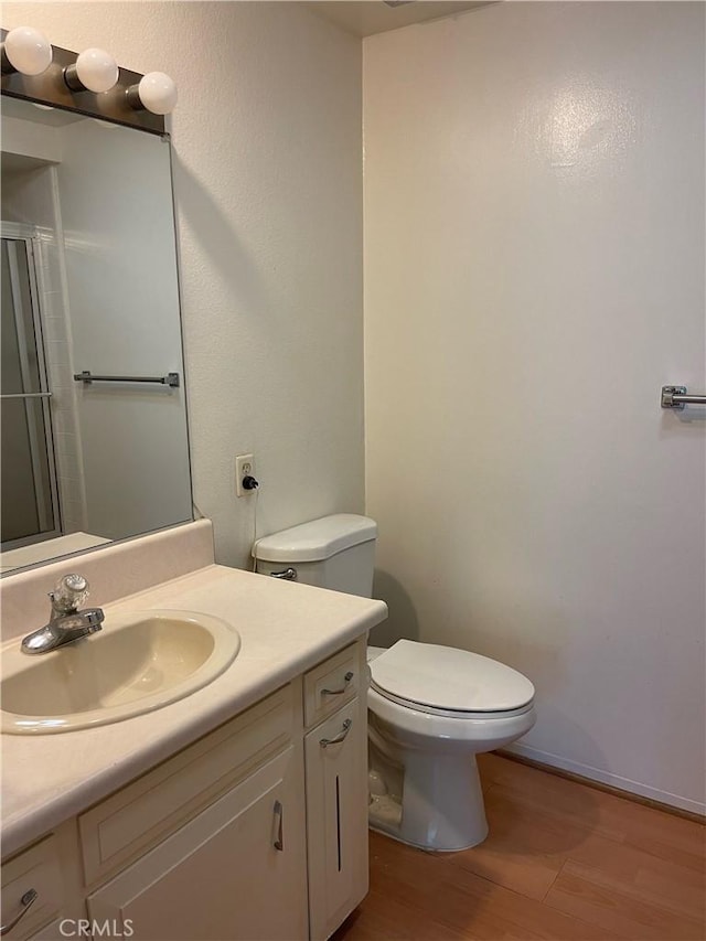 661 Avenida Sevilla Unit O, Laguna Woods, CA 92637 - full bath featuring wood finished floors, vanity, and a shower with door