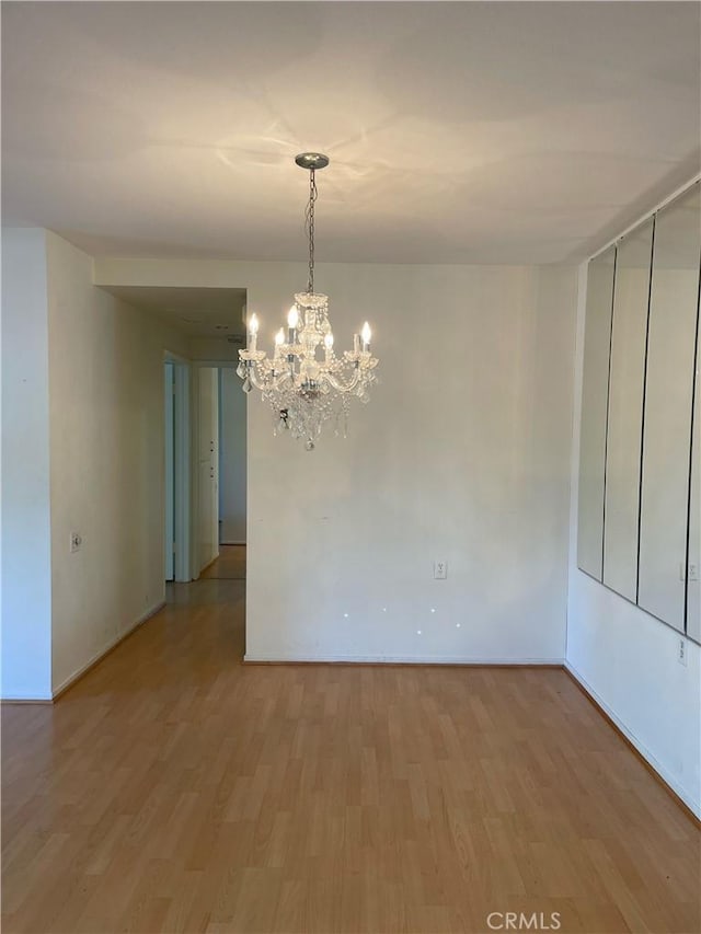 661 Avenida Sevilla Unit O, Laguna Woods, CA 92637 - spare room with light wood-style flooring and a chandelier