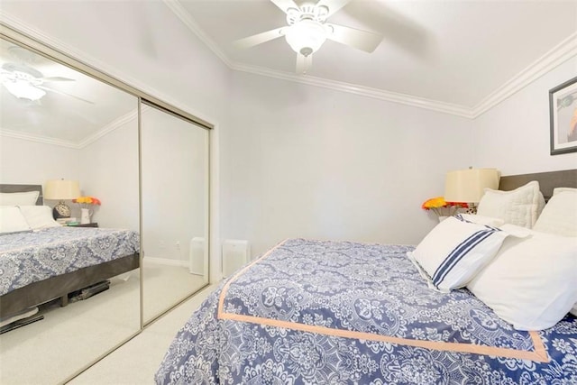 bedroom featuring ceiling fan, carpet, a closet, and ornamental molding