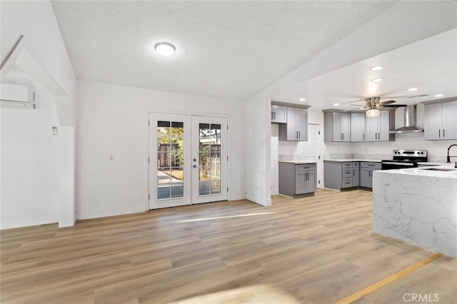 57526 Onaga, Yucca Valley, CA 92284 - kitchen featuring a textured ceiling, a ceiling fan, gray cabinetry, wall chimney exhaust hood, and electric stove