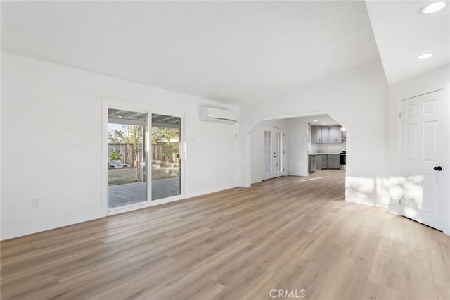 57526 Onaga, Yucca Valley, CA 92284 - unfurnished living room featuring recessed lighting, a wall mounted AC, light wood-style floors, and baseboards