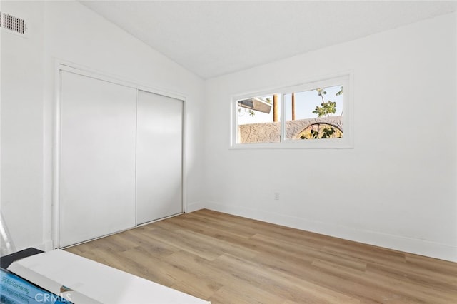 57526 Onaga, Yucca Valley, CA 92284 - unfurnished bedroom with visible vents, baseboards, a closet, light wood-type flooring, and vaulted ceiling
