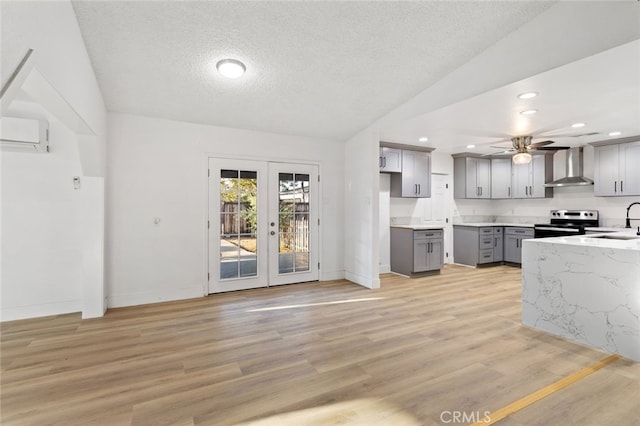 57526 Onaga, Yucca Valley, CA 92284 - kitchen with gray cabinets, wall chimney range hood, a textured ceiling, a ceiling fan, and electric stove