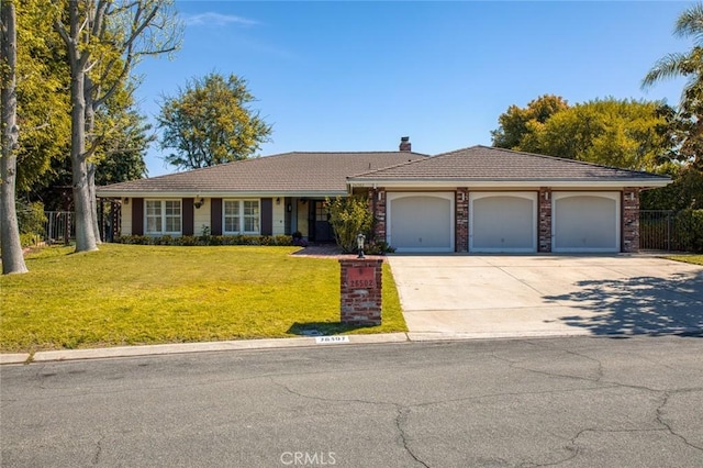 ranch-style house featuring a chimney, driveway, an attached garage, a front lawn, and fence