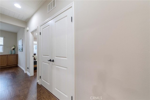 hallway with baseboards, visible vents, and recessed lighting