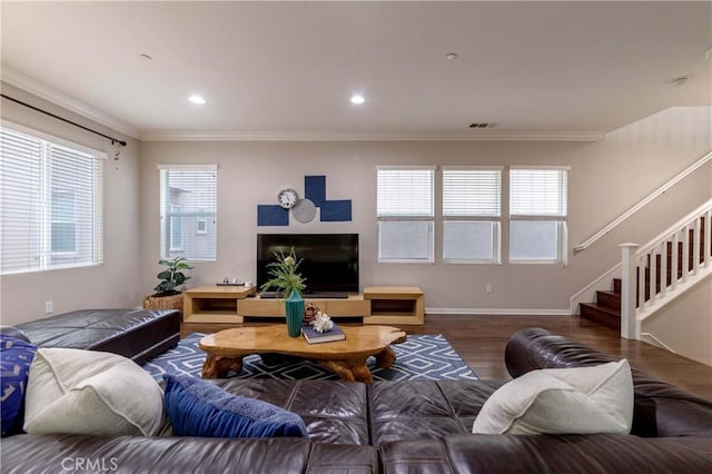 living area featuring stairway, a wealth of natural light, crown molding, and wood finished floors