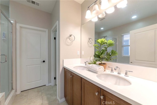 full bathroom featuring a sink, double vanity, and a stall shower