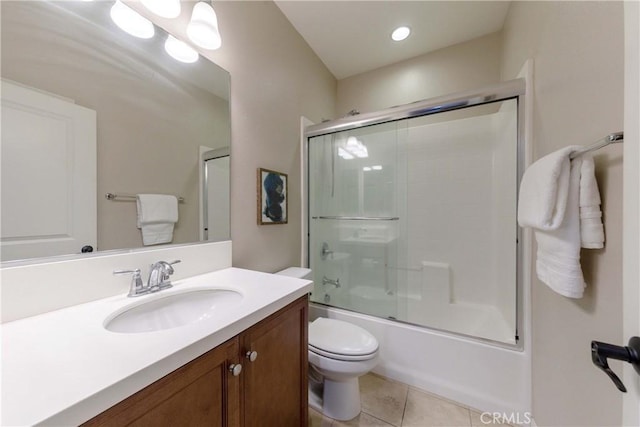 full bath featuring tile patterned floors, vanity, bath / shower combo with glass door, and toilet
