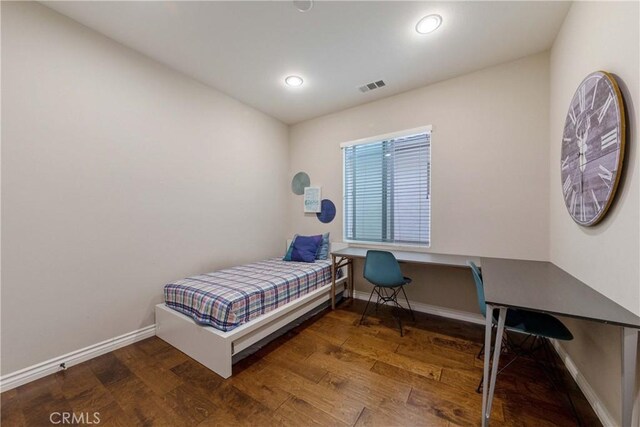 bedroom featuring baseboards, wood finished floors, visible vents, and recessed lighting