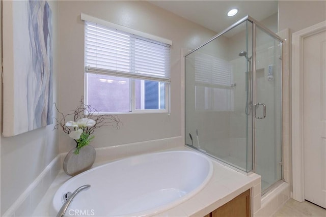 bathroom featuring a shower stall and a garden tub