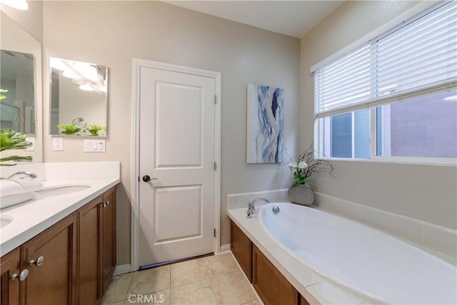 bathroom with a bath, a sink, tile patterned flooring, and double vanity
