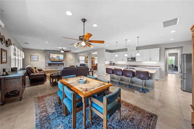 dining area featuring light tile patterned flooring, visible vents, a ceiling fan, and recessed lighting