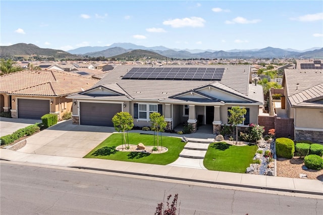 view of front of home featuring an attached garage, a tiled roof, concrete driveway, and a mountain view