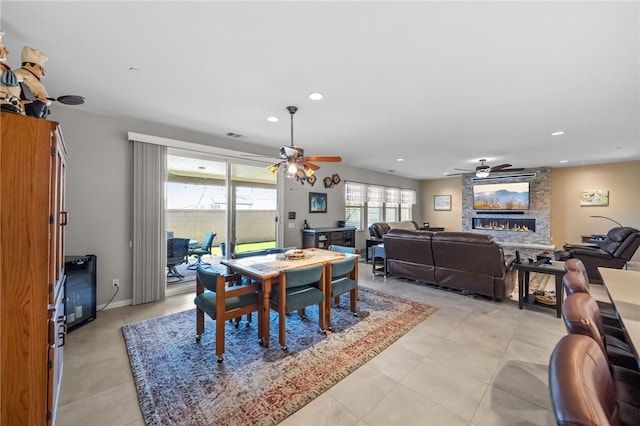 dining room featuring recessed lighting, a ceiling fan, and a fireplace