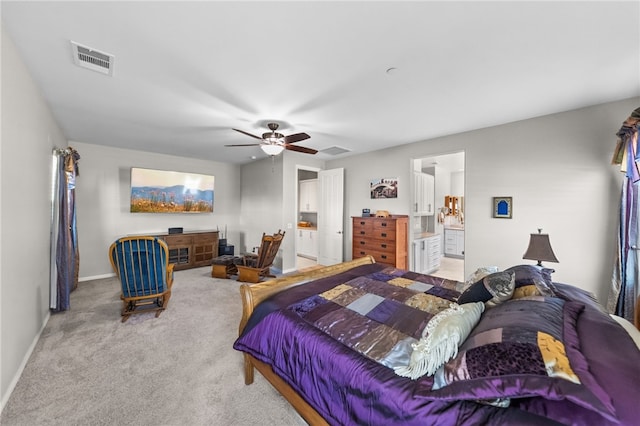 carpeted bedroom with visible vents, a ceiling fan, baseboards, and ensuite bathroom