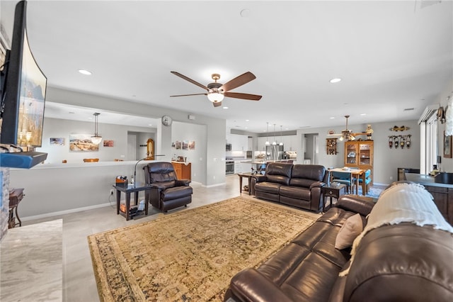 living room with ceiling fan, baseboards, and recessed lighting