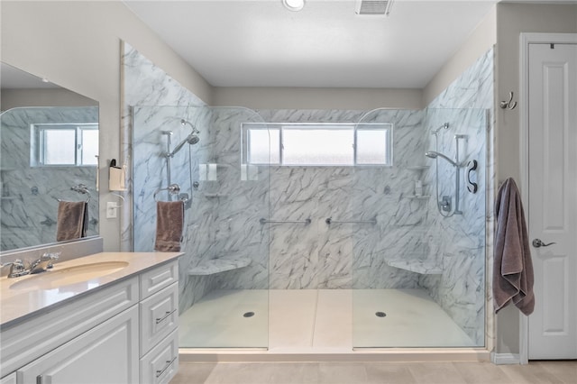 bathroom with visible vents, a wealth of natural light, vanity, and a marble finish shower