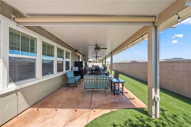 view of patio / terrace featuring ceiling fan, a fenced backyard, and outdoor dining space