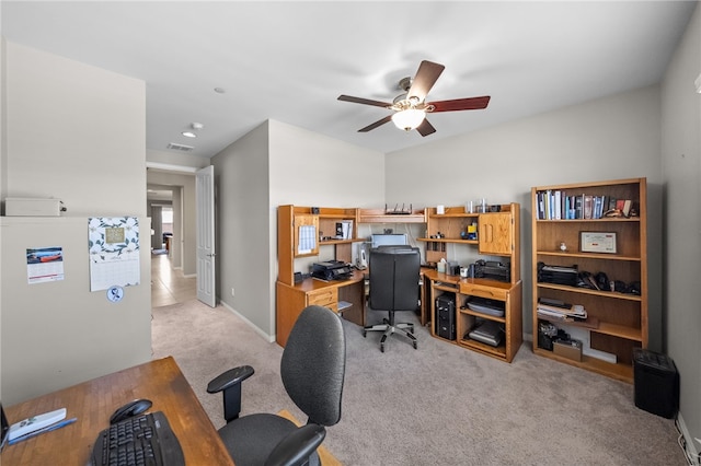 home office featuring visible vents, light carpet, baseboards, and ceiling fan