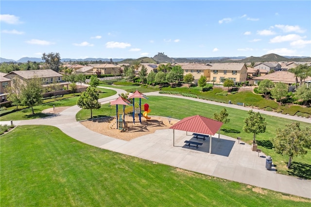 view of home's community with a residential view, a lawn, a mountain view, and playground community