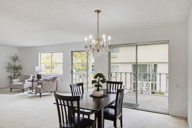 2399 Via Mariposa W Unit 2E, Laguna Woods, CA 92637 - dining area featuring carpet flooring, a chandelier, and a textured ceiling
