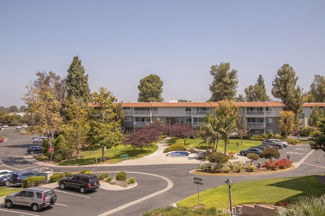 2399 Via Mariposa W Unit 2E, Laguna Woods, CA 92637 - view of building exterior featuring uncovered parking