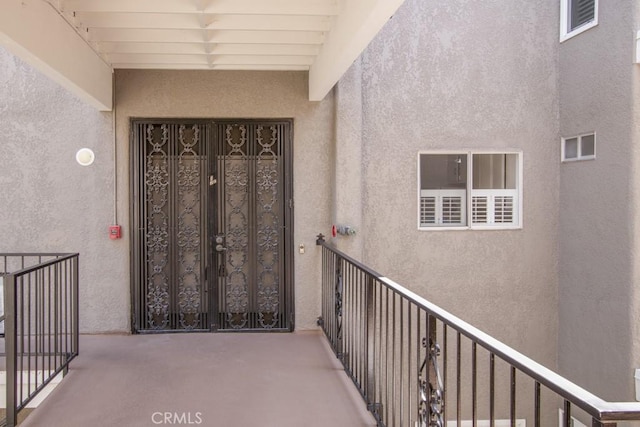 2399 Via Mariposa W Unit 2E, Laguna Woods, CA 92637 - doorway to property featuring stucco siding and a balcony