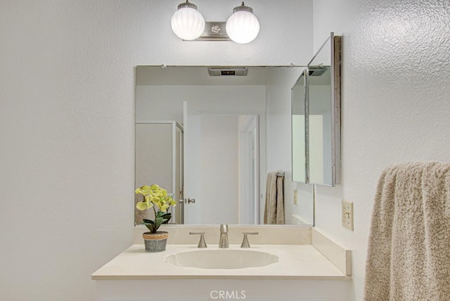 2399 Via Mariposa W Unit 2E, Laguna Woods, CA 92637 - bathroom featuring vanity and a textured wall