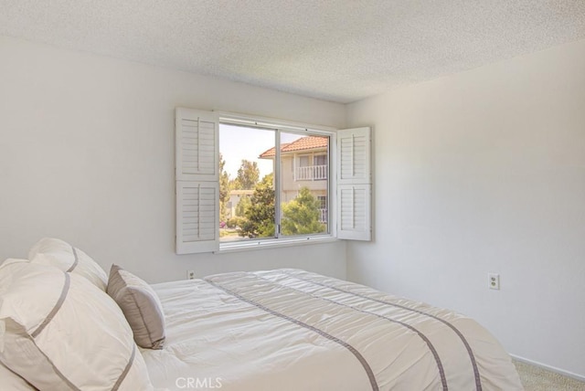 2399 Via Mariposa W Unit 2E, Laguna Woods, CA 92637 - bedroom with a textured ceiling and carpet floors