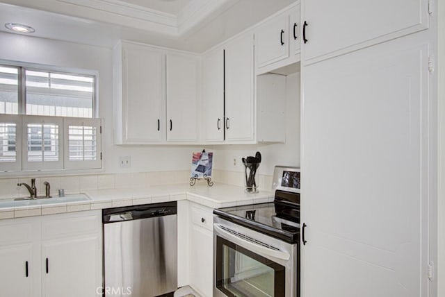 2399 Via Mariposa W Unit 2E, Laguna Woods, CA 92637 - kitchen featuring stainless steel appliances, crown molding, white cabinets, tile countertops, and recessed lighting