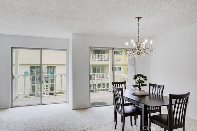 2399 Via Mariposa W Unit 2E, Laguna Woods, CA 92637 - carpeted dining room with a chandelier and a textured ceiling