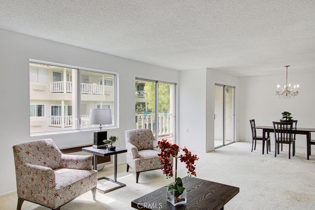 2399 Via Mariposa W Unit 2E, Laguna Woods, CA 92637 - carpeted living room featuring a chandelier and a textured ceiling