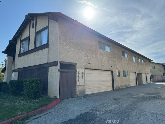 2453 S Ridgewood Dr, West Covina, CA 91792 - view of building exterior featuring a garage and asphalt driveway