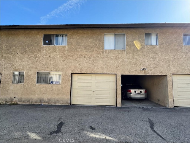 2453 S Ridgewood Dr, West Covina, CA 91792 - rear view of property featuring stucco siding and an attached garage