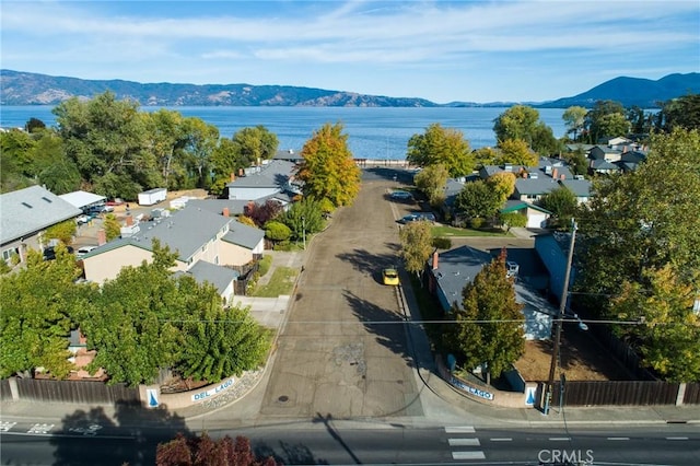 birds eye view of property featuring a water and mountain view and a residential view