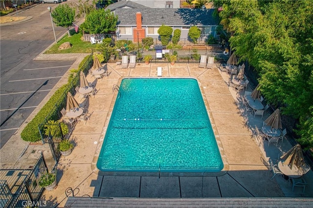pool featuring fence and a patio